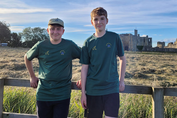two boys in front of Warkworth castle