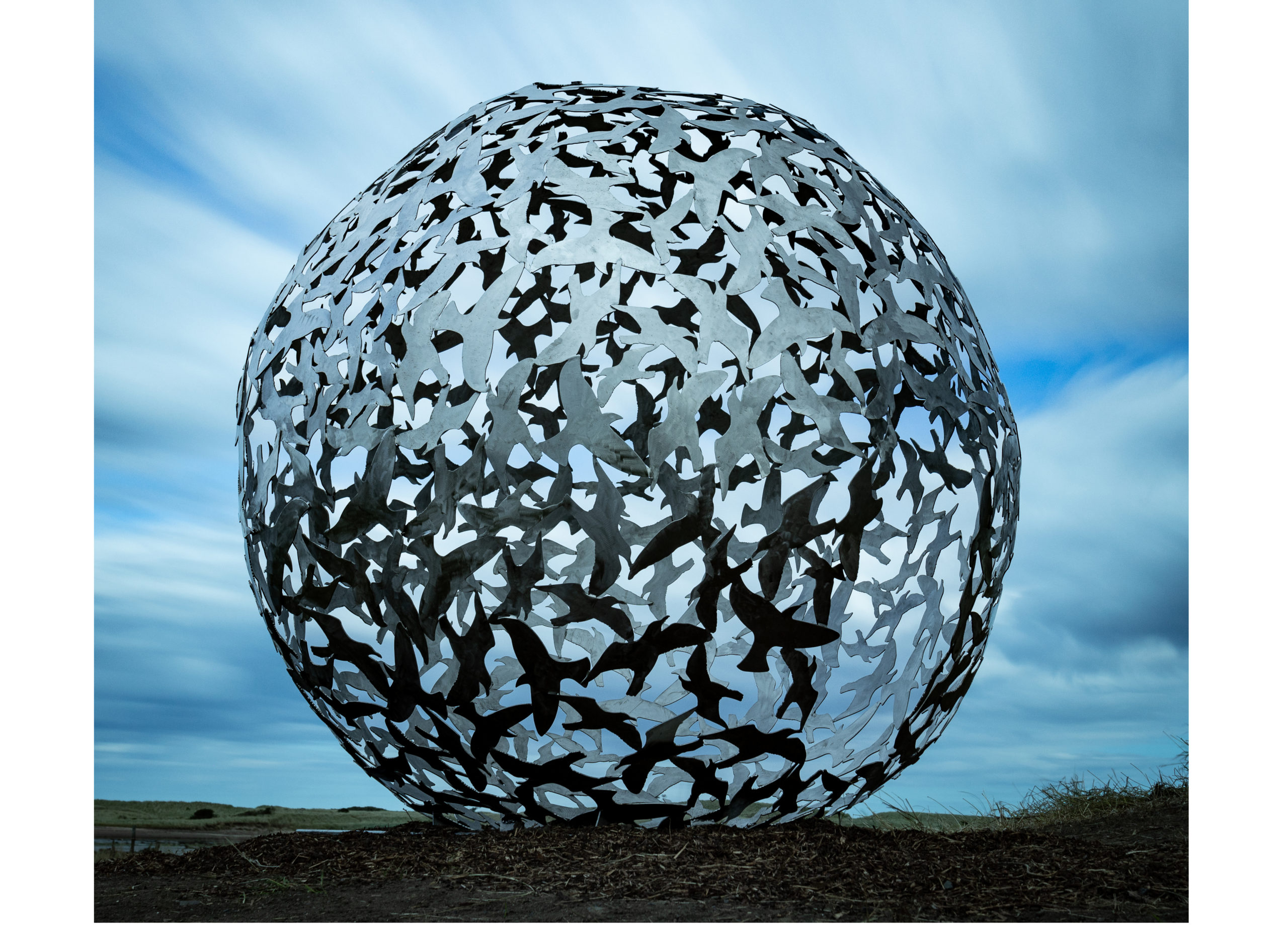 sculpture depicting a flock of birds in a spherical shape