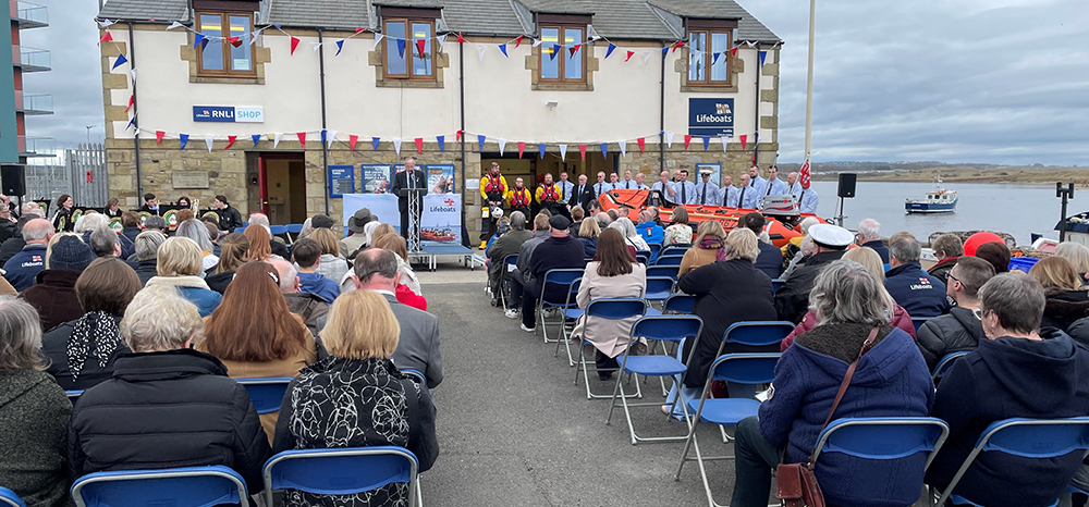 Invited guests seated in front of the Amble lifeboat station